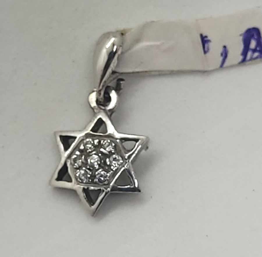 Handmade 14 carat white gold mini David star pendant set with seven Zirconia stones and forming a star of David, 1 cm X 0.2 cm X 2 cm approximately.