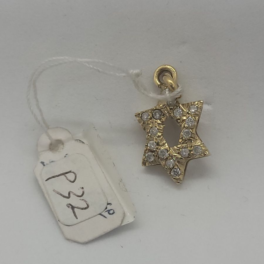 Handmade 14 carat yellow gold elongated Magen David pendant set with 15 Diamonds, clarity VS and total weight 32PTS forming a star of David.